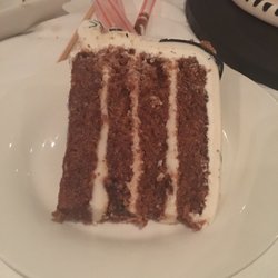 Carolina Cake Artistry - The base is carrot. Dense but moist. Frosting was too sweet which I like!