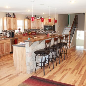 Ascending Floors - a kitchen with a center island and bar stools - Flooring Near Me - Colorado Springs, Colorado Ascending Floors - a kitchen with a center island and bar stools - Flooring Near Me - Colorado Springs, Colorado