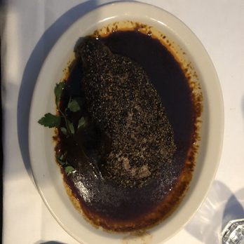 Harry & Izzy's - Peppercorn crusted NY Strip cooked medium with orange brandy sauce. - Steakhouses Near Me - Indianapolis, Indiana Harry & Izzy's - Peppercorn crusted NY Strip cooked medium with orange brandy sauce. - Steakhouses Near Me - Indianapolis, Indiana