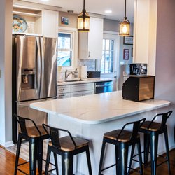 Aladdin Carpet & Floors - Modern Kitchen with white cabinet and subway backsplash and hardwood floor Design and installed by Aladdin carpet and floors