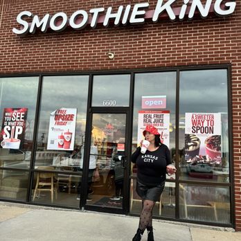 Smoothie King - a woman walking in front of a smoothie king store - Juice Bars & Smoothies Near Me - Mission, Kansas