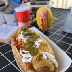Red Rock Dogs - New! NACHO DOG! All beef 1/4lb dog, nacho cheese, tomatoes, onions, jalapeños, seasoned tortilla chips, and sour cream!!