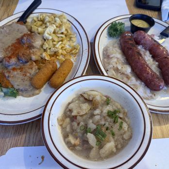 Helga's German Restaurant & Deli - Rahm Schnitzel mit Spätzle und Kroketten, Bratwurst Platter mit Sauerkraut, und Potato Salat - German Near Me - Aurora, Colorado Helga's German Restaurant & Deli - Rahm Schnitzel mit Spätzle und Kroketten, Bratwurst Platter mit Sauerkraut, und Potato Salat - German Near Me - Aurora, Colorado