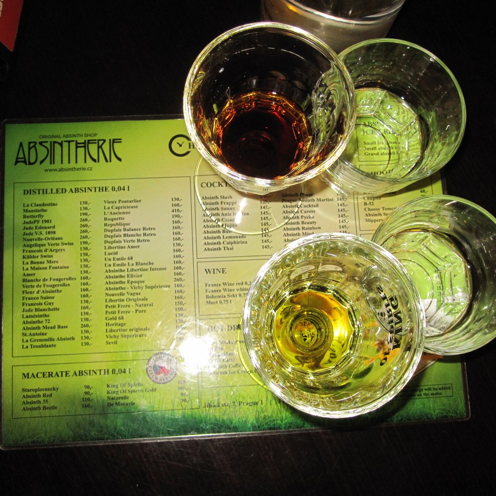 Absintherie - King of Spirits (bottom) and Absinth Beetle (top) (with accompanying glasses of water) - Cocktail Bars Near Me - Prague, Puerto Rico Absintherie - King of Spirits (bottom) and Absinth Beetle (top) (with accompanying glasses of water) - Cocktail Bars Near Me - Prague, Puerto Rico