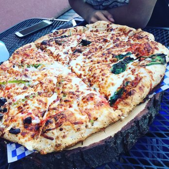 The Sawdust Bakery - a large pizza on a table - Bakeries Near Me - Kelowna, British Columbia The Sawdust Bakery - a large pizza on a table - Bakeries Near Me - Kelowna, British Columbia