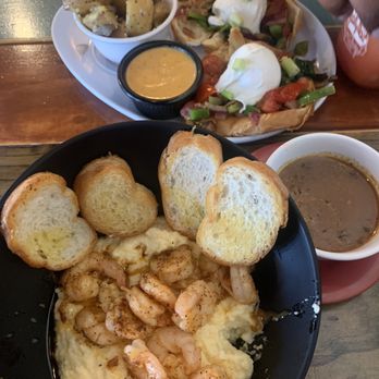 Two Chicks Cafe - Barbecue Shrimp and Grits. Roux on the side. Vegan eggs benedict on a croissant with potatoes. An alternative hollindaise sauce. - Breakfast & Brunch Near Me - New Orleans, Louisiana