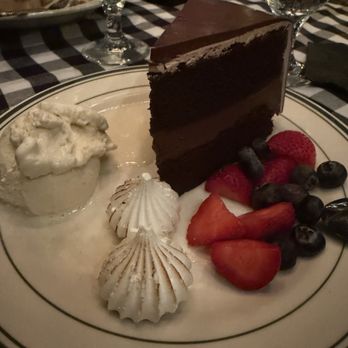 Manhattan Restaurant - Homemade chocolate cake with vanilla ice cream and berries - Steakhouses Near Me - Fresno, California Manhattan Restaurant - Homemade chocolate cake with vanilla ice cream and berries - Steakhouses Near Me - Fresno, California