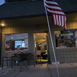 THNK - Nighttime storefront view at Rogue River, OR HQ