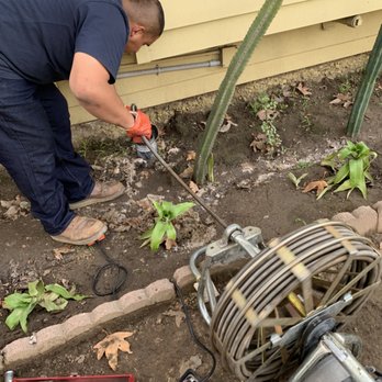 Mr Sewer Man - Our technician is running the main sewer machine to attempt to clear the root intrusion in this clay pipe. - Plumbing Near Me Mr Sewer Man - Our technician is running the main sewer machine to attempt to clear the root intrusion in this clay pipe. - Plumbing Near Me