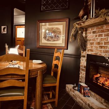 Hunter & Thief - a dining room with a fireplace - Cocktail Bars Near Me - Lindenhurst, New York
