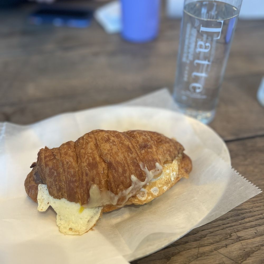 Tatte Bakery & Cafe | Assembly Row - Breakfast sandwich on croissant roll - Breakfast & Brunch Near Me - Somerville, Massachusetts Tatte Bakery & Cafe | Assembly Row - Breakfast sandwich on croissant roll - Breakfast & Brunch Near Me - Somerville, Massachusetts