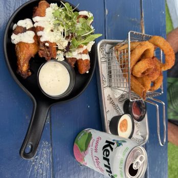 Rosemarie's Buns and Brews - Honey Buffalo Wings and Classic Onion Rings with a kerns Guava Nectar - Burgers Near Me - Encinitas, California Rosemarie's Buns and Brews - Honey Buffalo Wings and Classic Onion Rings with a kerns Guava Nectar - Burgers Near Me - Encinitas, California