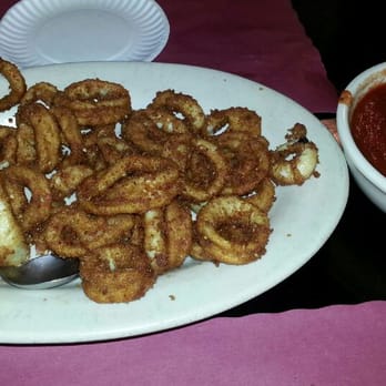 Krug's Tavern - Calamari and bowl of tomato sauce with red pepper flakes. - Dive Bars Near Me - Newark, New Jersey