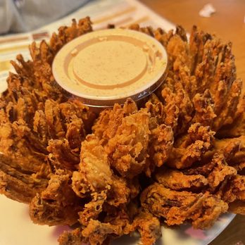 Texas Roadhouse - a plate of fried onion rings with a dipping sauce - Steakhouses Near Me - Walpole, Massachusetts Texas Roadhouse - a plate of fried onion rings with a dipping sauce - Steakhouses Near Me - Walpole, Massachusetts