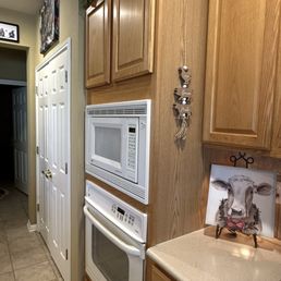 The separate microwave and oven wall unit that needed to be replaced.