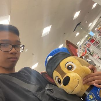 Ala Moana Center - Photographer taking a photo of himself holding a Chase plush from the TV series Paw Patrol. - Shopping Centers Near Me - Honolulu, Hawaii