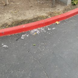 Glass ( I had to sweep out of the driveway) that's been there for over a week. Glass ( I had to sweep out of the driveway) that's been there for over a week.