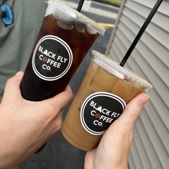 Black Fly Coffee - two people holding drinks - Coffee & Tea Near Me - Holden, Maine