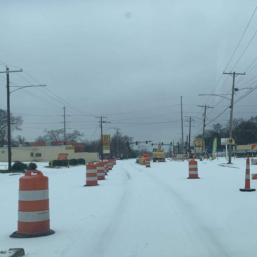 Walgreens - a snow covered road with orange and white cones - Drugstores Near Me - Jackson, Mississippi