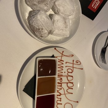Red, the Steakhouse - Beignets with chocolate fudge, caramel sauce and raspberry sauce - Steakhouses Near Me - Orange Village, Ohio Red, the Steakhouse - Beignets with chocolate fudge, caramel sauce and raspberry sauce - Steakhouses Near Me - Orange Village, Ohio