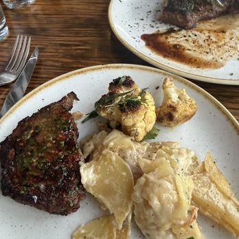 FlintCreek Cattle - Half a ribeye, potato side dish similar to scalloped potatoes and roasted cauliflower. - New American Near Me - Seattle, Washington