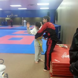 Murray's Martial Arts - Sensei Dylan awarding my son with his yellow belt :-) We love Dylan! His enthusiasm is through the roof!