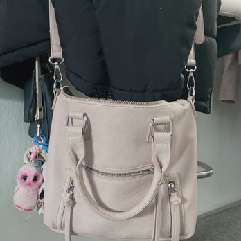 TJ Maxx - Lighting is off - pink medium-sized purse with long strap & short handles, 3 zippered pockets, 5 pockets in total. - Department Stores Near Me - Buena Park, California