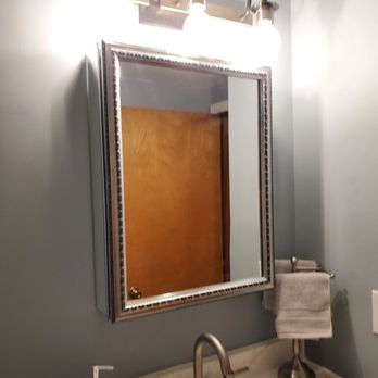 C.R. Boyd Construction -  a bathroom with a sink and mirror - General Contractors Near Me