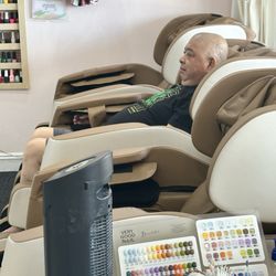Three massage chairs in waiting area