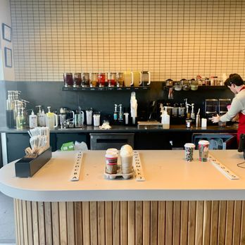 Starbucks - a woman standing at a counter in a coffee shop - Coffee & Tea Near Me - Sioux Falls, South Dakota