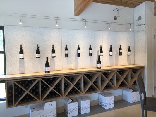 Photo of Avennia - Woodinville, WA, US. a wall of wine bottles on display