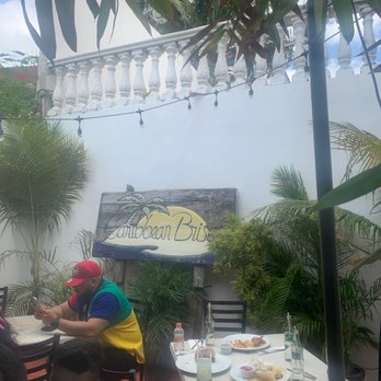 Caribbean Brisas - The sign and couple tables - Seafood Near Me - Isla Mujeres, ROO