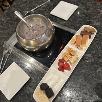 The Melting Pot - Desert and lavender syrup with smashed blackberries and white chocolate, dipping sauce fruits, and pastries - Fondue Near Me - Orlando, Florida The Melting Pot - Desert and lavender syrup with smashed blackberries and white chocolate, dipping sauce fruits, and pastries - Fondue Near Me - Orlando, Florida