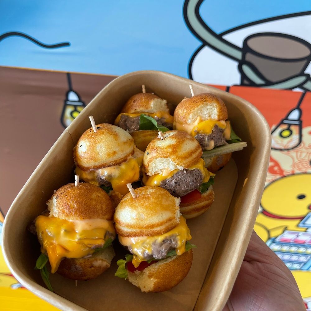 Good Day Cafe - a hand holding a tray of mini cheeseburgers - Cafes Near Me - Richmond, British Columbia
