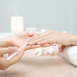 Fellini Nail Studio - Nail artist performing manicure service.