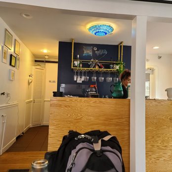 Jahunger - Providence - a woman behind a counter in a kitchen - Asian Fusion Near Me - Providence, Rhode Island