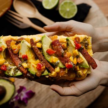 Queso At Casa - a person holding a slice of quesadilla - Sandwiches Near Me - Easton, Pennsylvania
