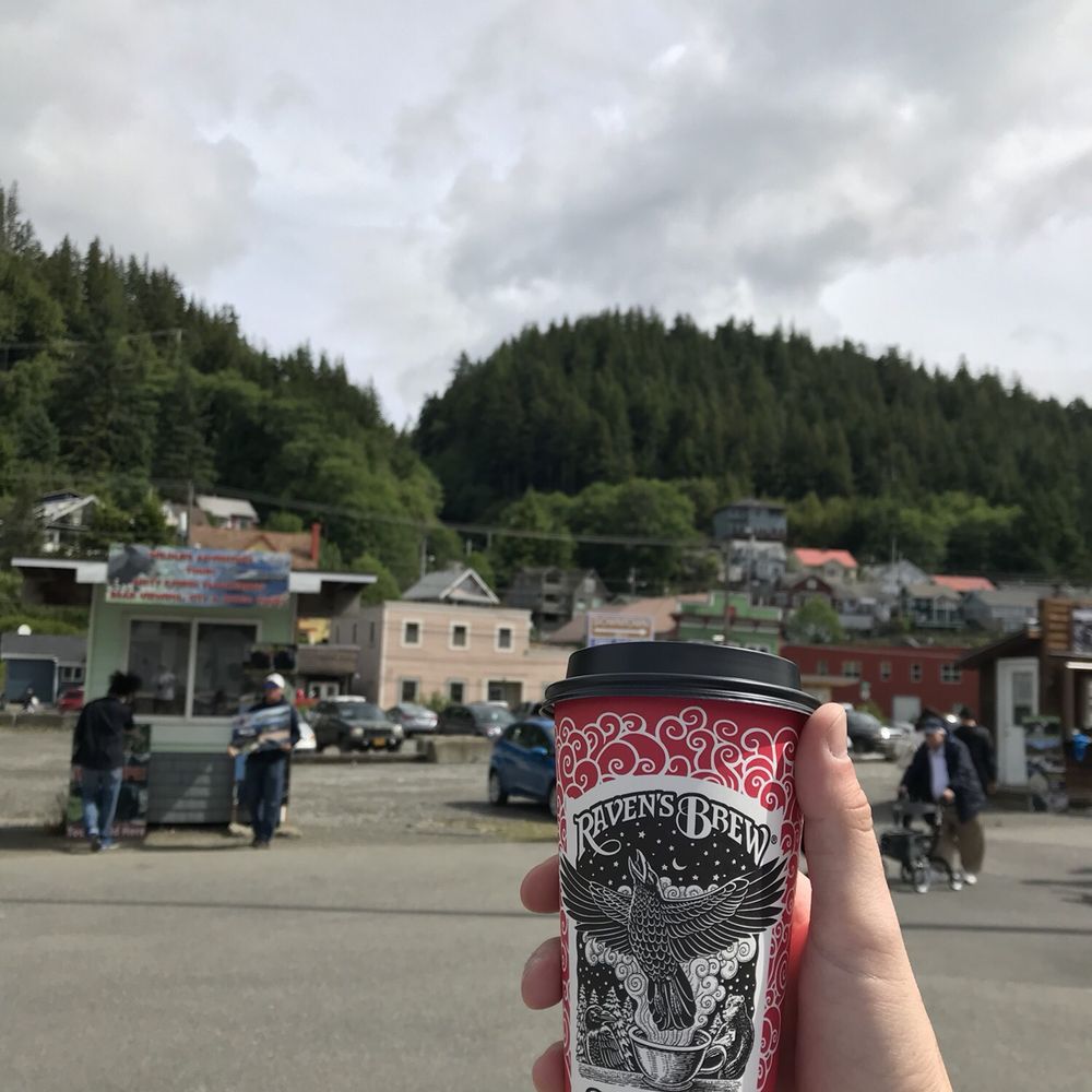 a hand holding a cup of coffee a hand holding a cup of coffee