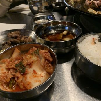 The Cast Iron Pot 3 - The sides: rice, sesame soy sauce and delicious kimchi - Korean Near Me - Flushing, New York