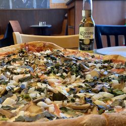 Luigi's Pizza - 5 topping veggie pizza, with a cold Corona beer.