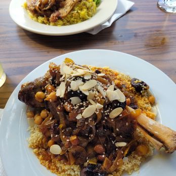 Abigail's Moroccan Cuisine - Lamb shank with raisins,prunes, and carmelized onions on a bed of couscous. And the chicken with saffron rice and caramelized onions. - Moroccan Near Me - Alameda, California Abigail's Moroccan Cuisine - Lamb shank with raisins,prunes, and carmelized onions on a bed of couscous. And the chicken with saffron rice and caramelized onions. - Moroccan Near Me - Alameda, California