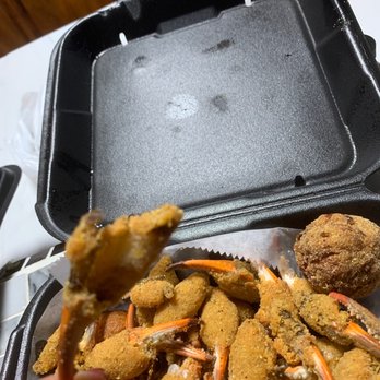 Killer Crab and Seafood - a person holding a piece of crab - Seafood Near Me - Gautier, Mississippi Killer Crab and Seafood - a person holding a piece of crab - Seafood Near Me - Gautier, Mississippi