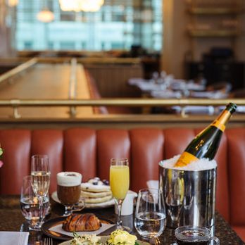 fl.2 - a table with a bottle of champagne and a plate of food - New American Near Me - Pittsburgh, Pennsylvania