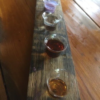Willie's Distillery - Tasting board (a barrel stave).  Bourbon, rye, mixed berry moonshine, and huckleberry cream liquer - Distilleries Near Me - Ennis, Montana