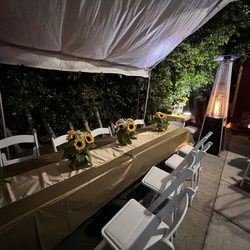 Party Palooza - Beautiful floral center pieces, white resin chairs with comfortable padding, and an amazing heating that set a warm evening glow.