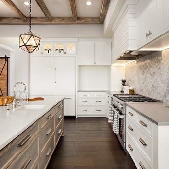 JC Construction - a kitchen with white cabinets and marble countertops - General Contractors Near Me JC Construction - a kitchen with white cabinets and marble countertops - General Contractors Near Me
