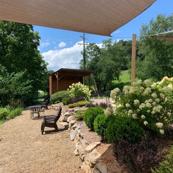 Currahee Brewing Company - a patio area with seating and flowers - Breweries Near Me - Franklin, North Carolina