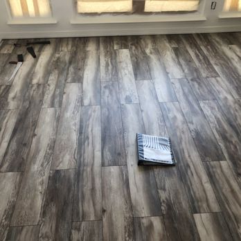 One Above Legacy - a hardwood floor in a living room - Handyman Near Me