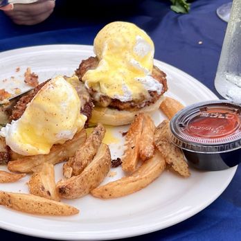 Maxine's On Shine - Poached eggs over fried green tomatoes with fries. - New American Near Me - Orlando, Florida Maxine's On Shine - Poached eggs over fried green tomatoes with fries. - New American Near Me - Orlando, Florida
