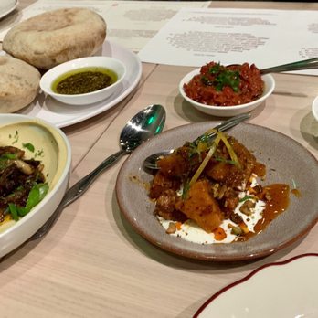 Safta - Pita & Mushroom hummus with an assortment of Salatim (appetizers) - Middle Eastern Near Me - Denver, Colorado